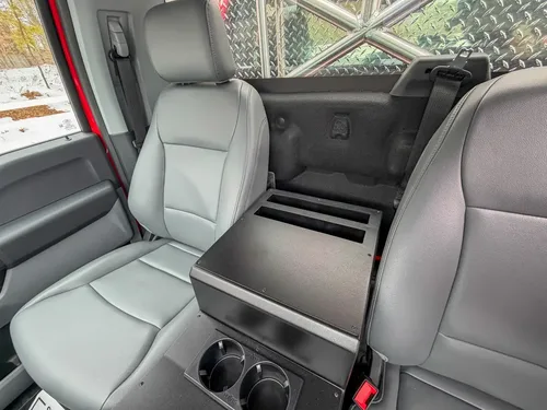 Rear seating area with fold-down center section behind front seats.